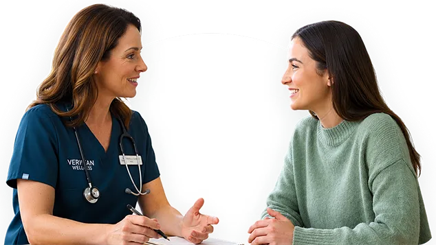 A clinician talking with a patient during a visit